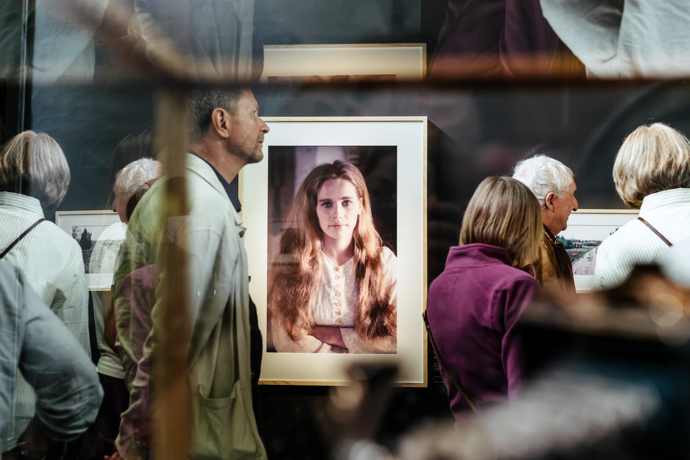 Visitors among the framed photographs in the Jan Troell exhibition